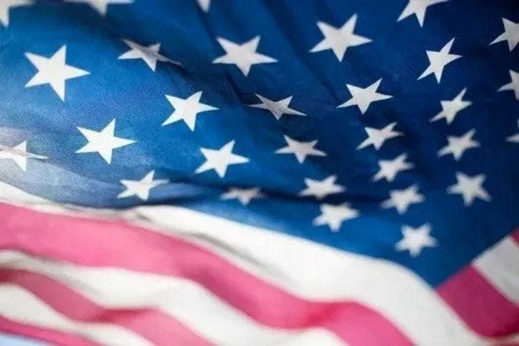 American flag waving with focus on stars and stripes.